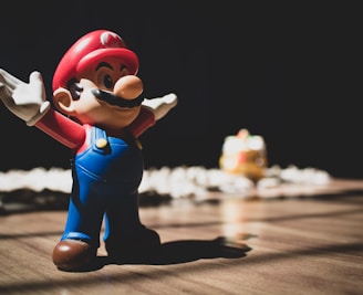 Super Mario figurine on brown surface