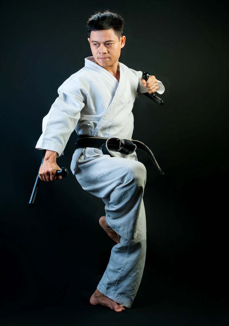 Martial artist holding a high kick stance mid-competition