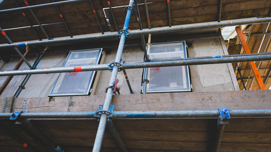 Scaffold tubes and boards fixed to a house wall