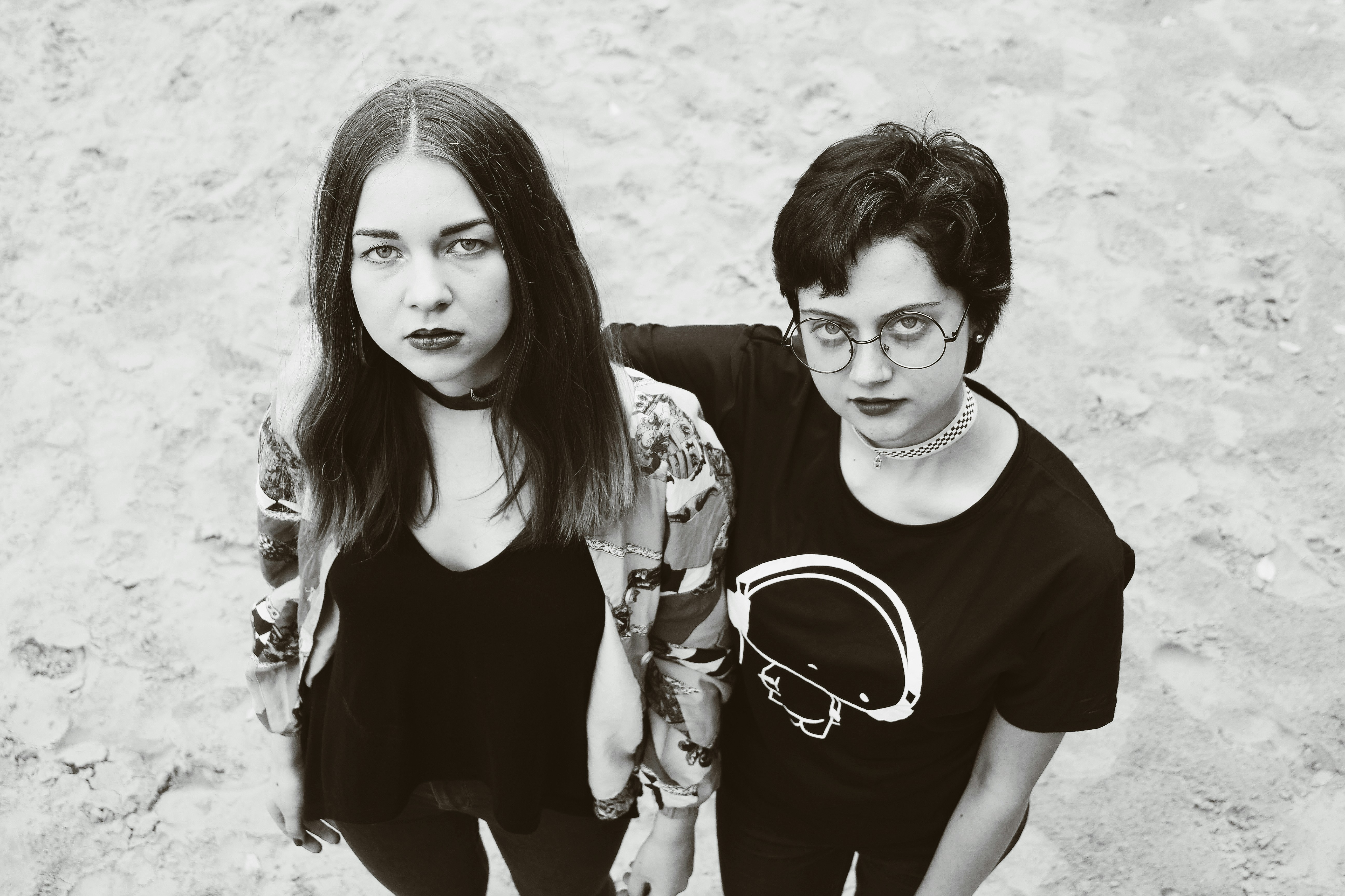grayscale photography of two women looking up (Photo by Matas Katinas on Unsplash)