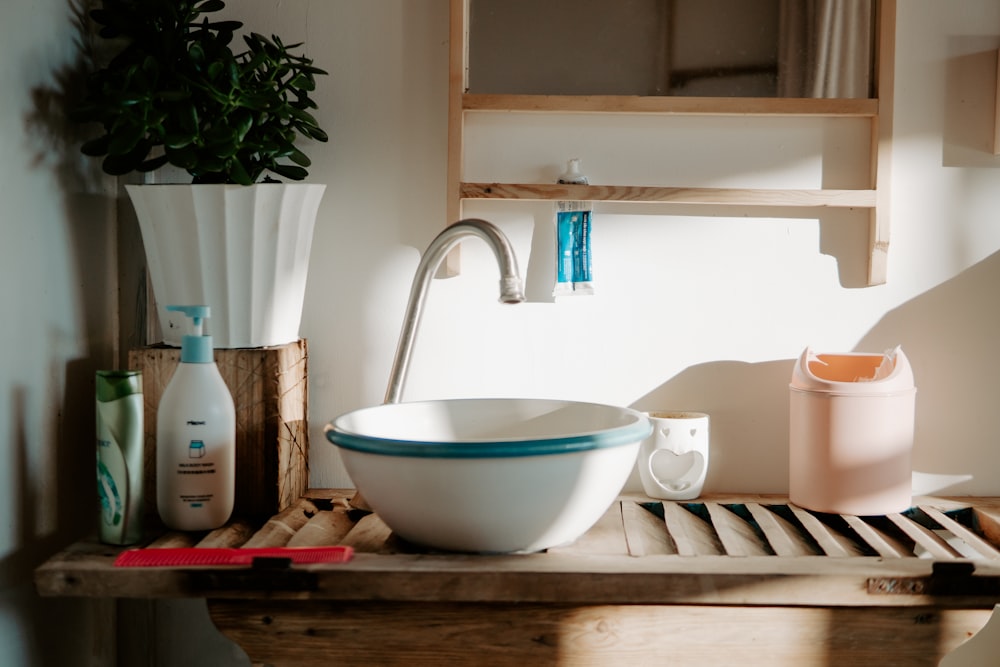 white and teal ceramic sink with gray faucet