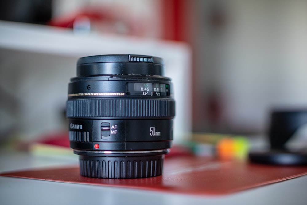 selective focus photography of black Canon camera lens