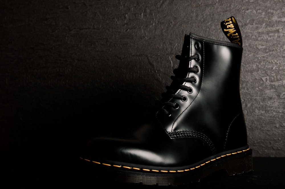 unpaired black leather boot