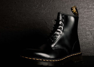 unpaired black leather boot