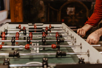 person playing foosball table