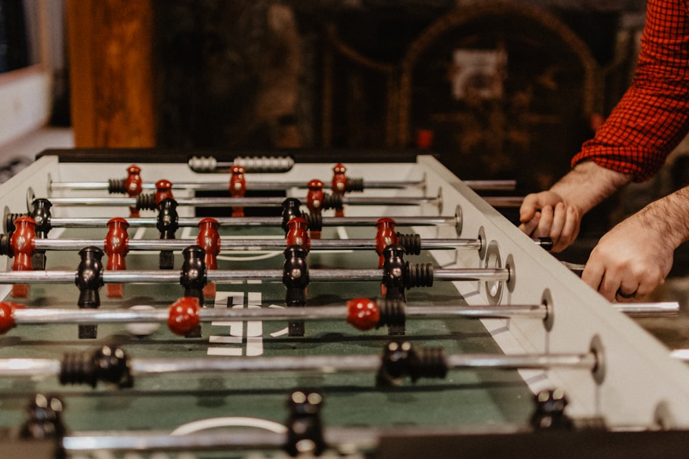 person playing foosball table