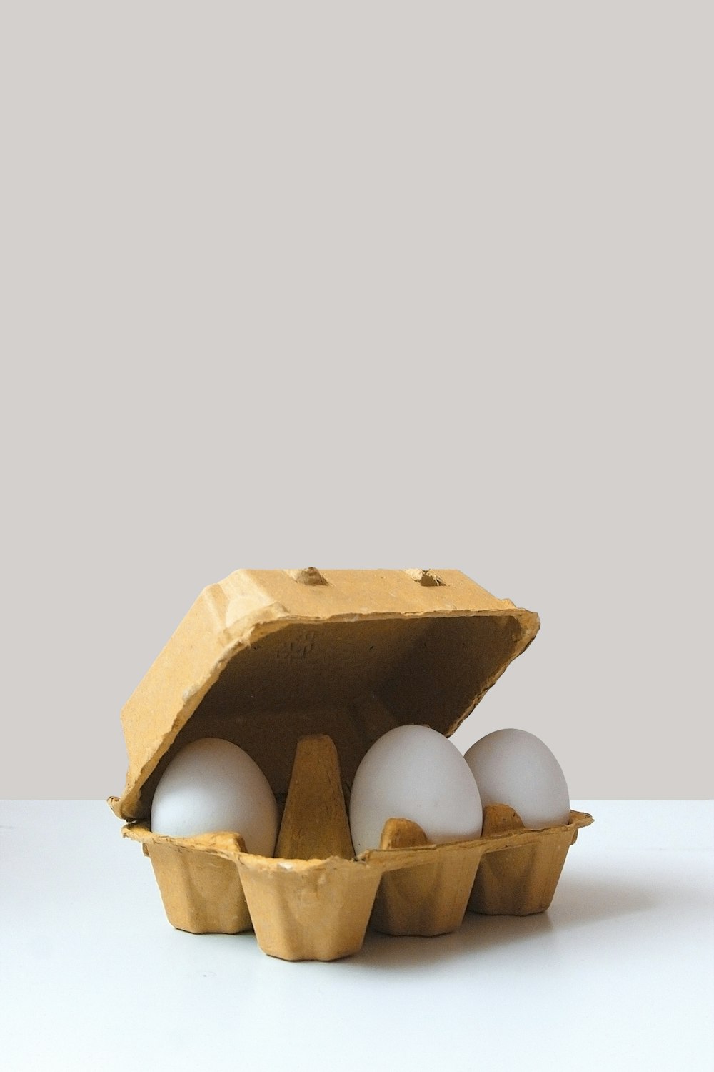 three white eggs inside tray