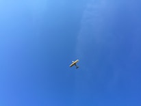 A small aircraft soaring above the Western Ghats with clear blue skies.