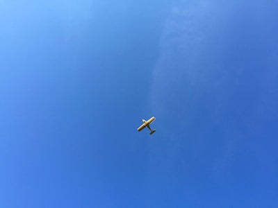 A small aircraft soaring above the Western Ghats with clear blue skies.