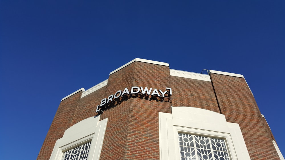 brown building with Broadway signage during daytime