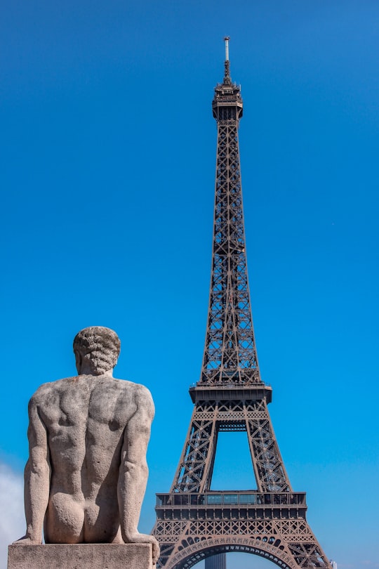 man's sculpture and Eiffel Tower in Eiffel Tower France