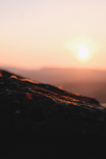 Photographer capturing a serene landscape during golden hour with soft natural light.