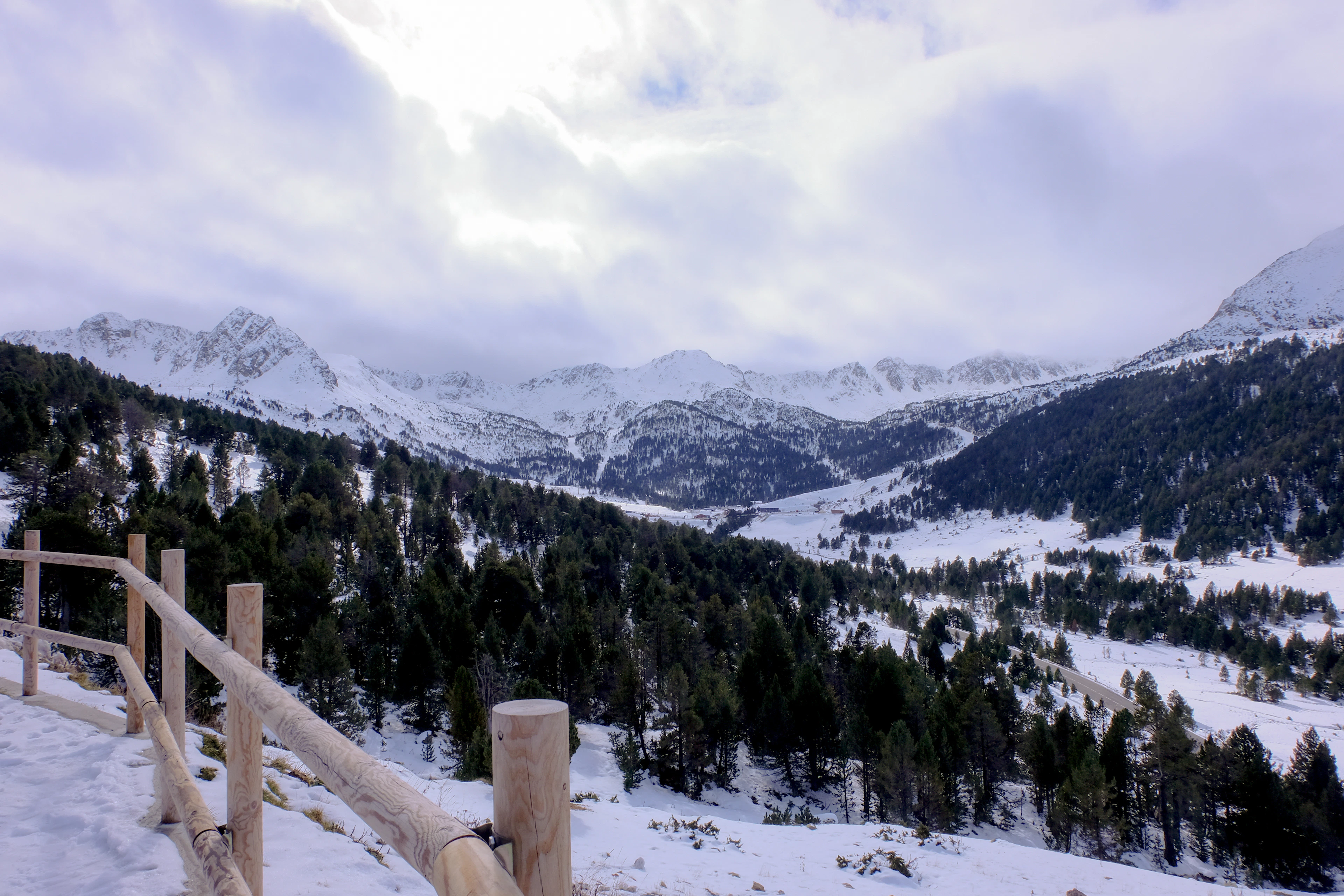 A wooden fence across a snowy field in Andorra
