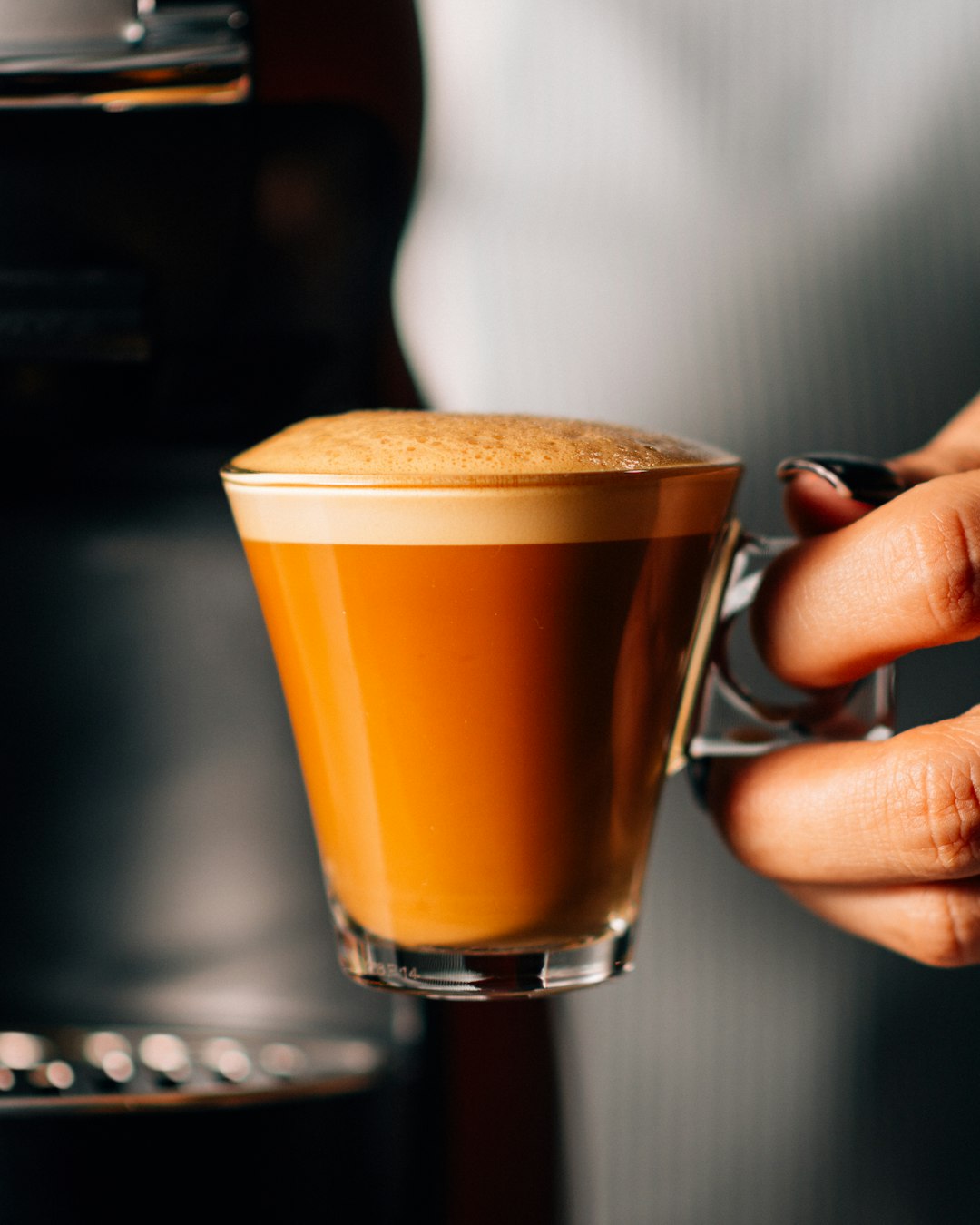 person holding cup of espresso