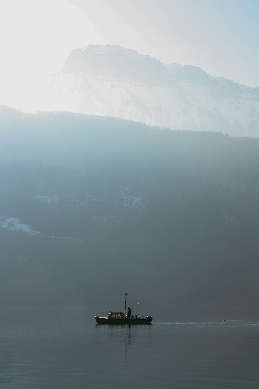 fishing boat near mountain