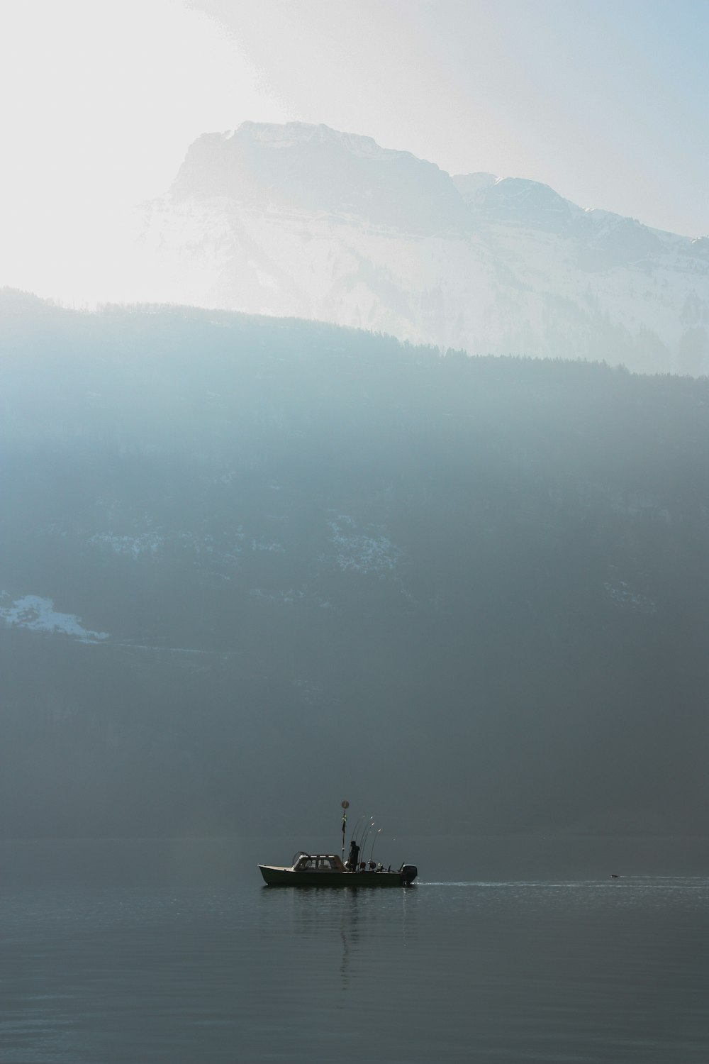 fishing boat near mountain