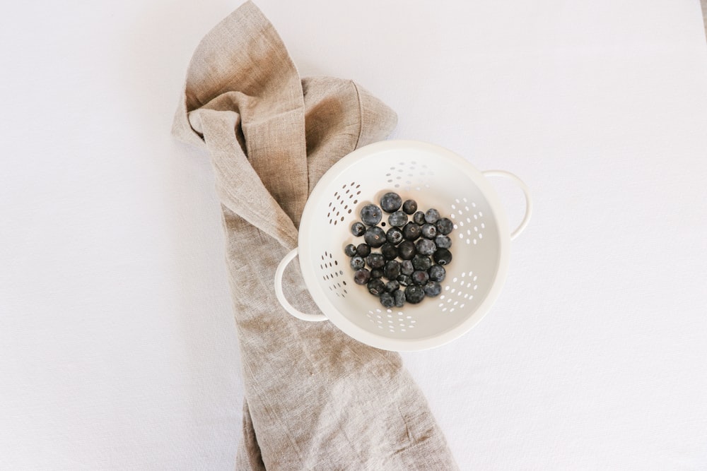 round white colander with blackberries