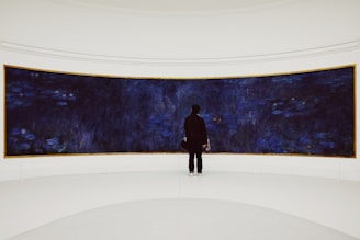 person standing beside blue wall