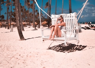 woman sitting on swing bench