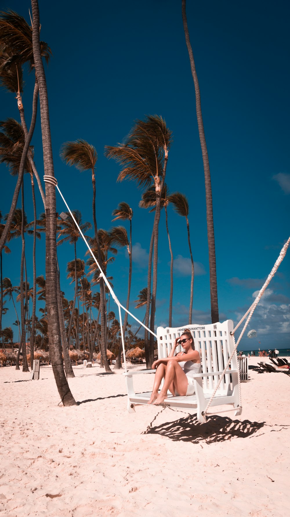 woman sitting on swing bench