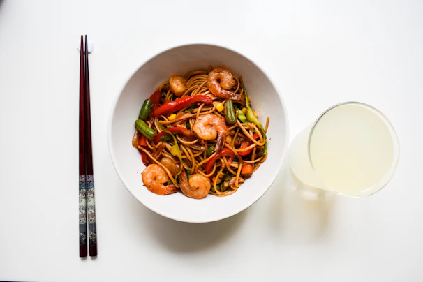 A vibrant display of colorful Asian noodles in various shapes and sizes.
