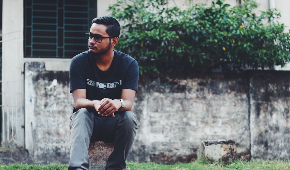 man wearing black t-shirt and gray jeans