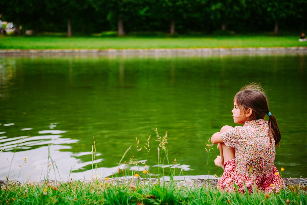 girl sitting on grass field