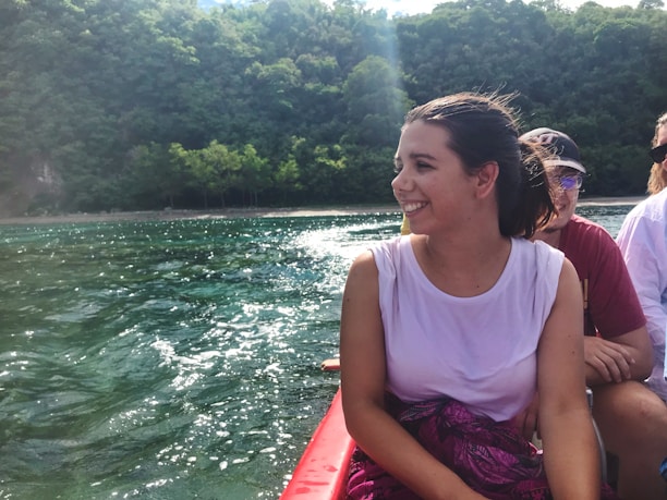 A happy guest stepping onto a small boat ready for a day on the water.