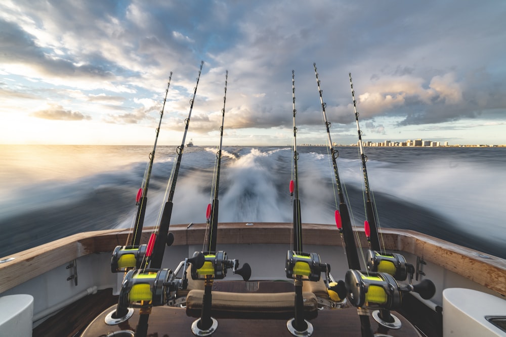 seis vara de pesca preta e amarela no barco