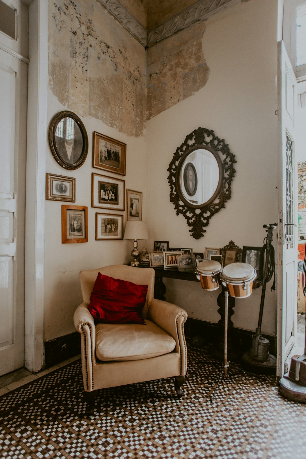 brown fabric sofa chair beside white wall