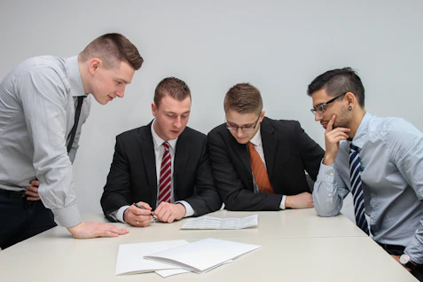 A team of consultants reviewing detailed financial reports around a table.