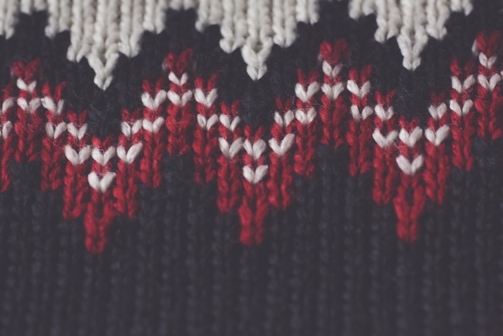 black, white, and red knit garment