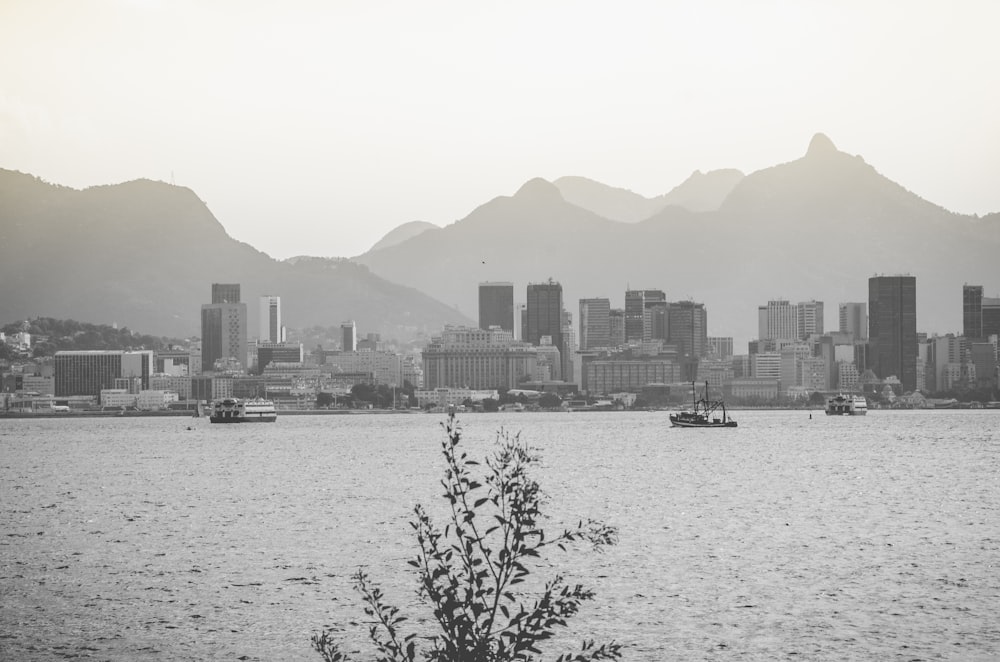 city near body of water grayscale photo