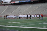 Panoramic photo of the full team lined up on the field before kickoff