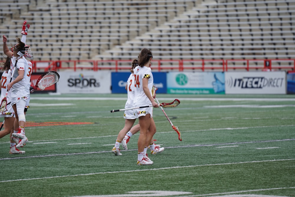 women playing lacrosse at the field