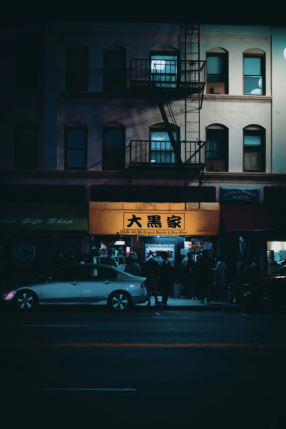 silver sedan parked near sidewalk