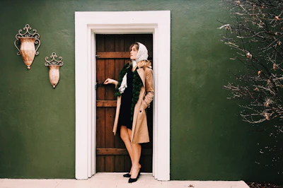 woman standing beside door during daytime