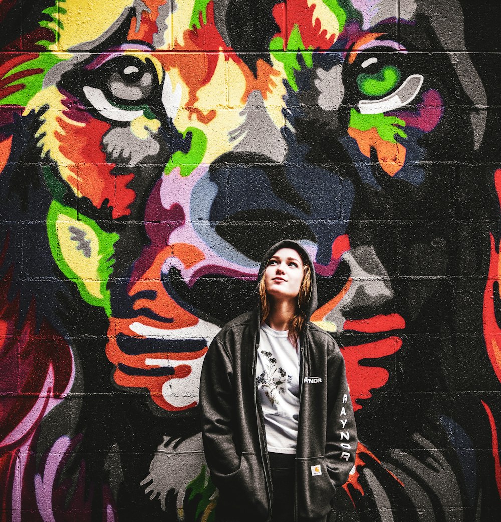Woman Standing Beside Black And Red Dog Painted Wall Photo Free