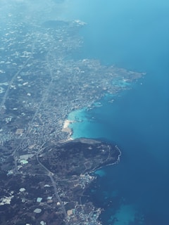 Bird's-eye view of a coastal area with clear blue waters.