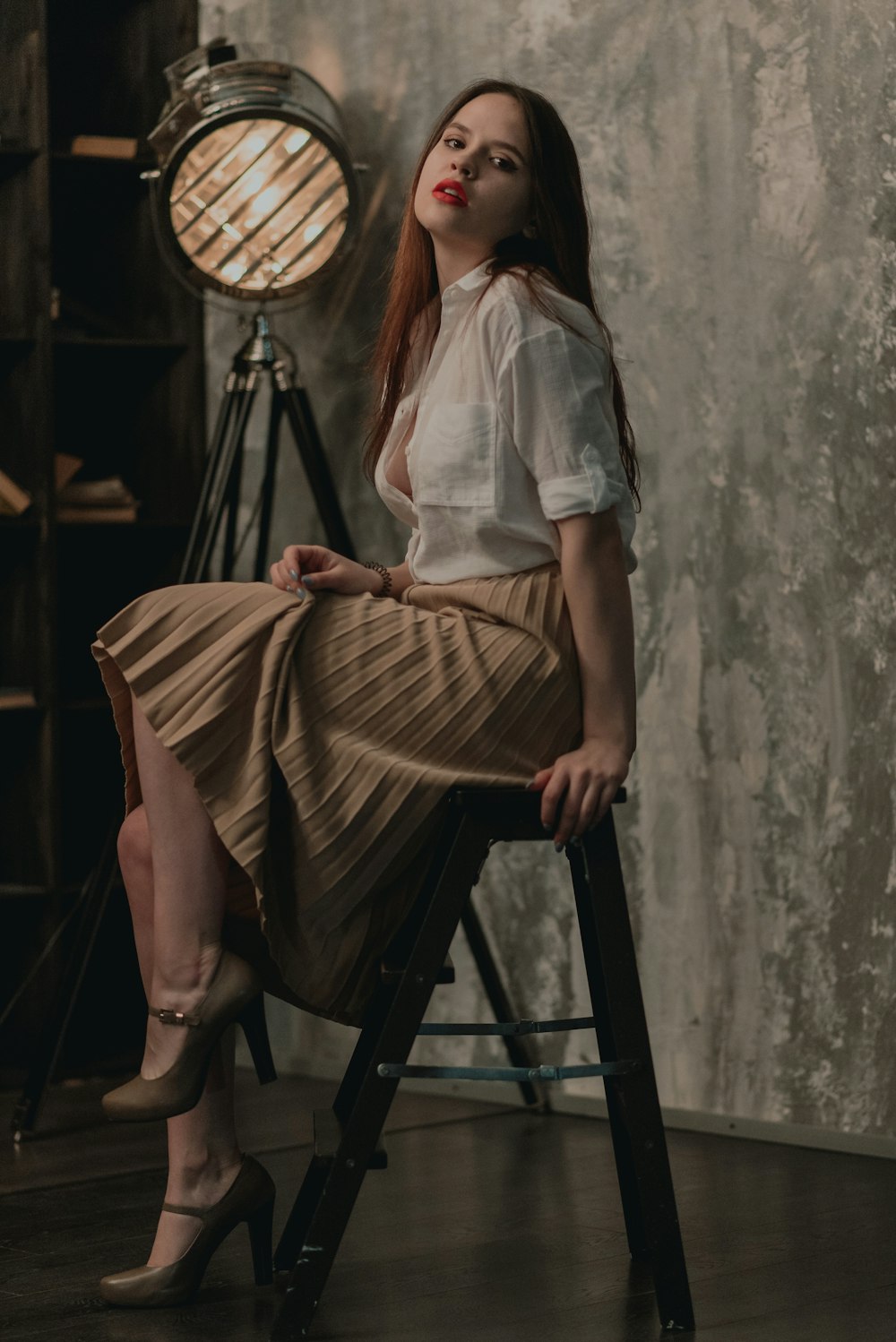 woman sitting on chair in stage