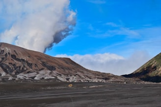 mountain under blue sky and white clouds at daytime