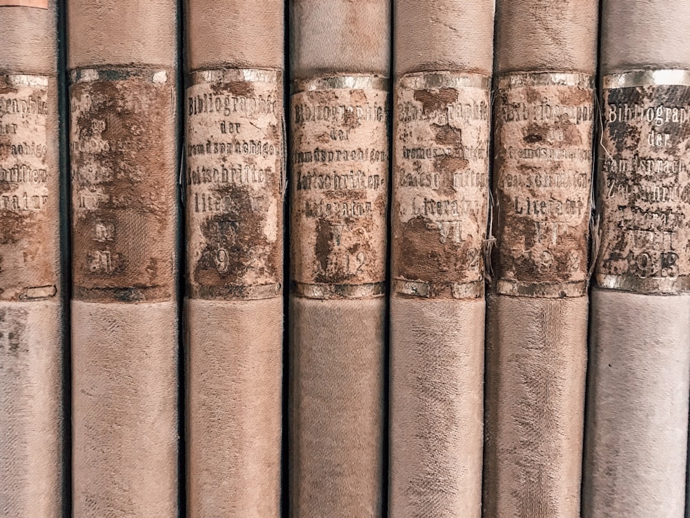 close-up photo of seven brown vintage books