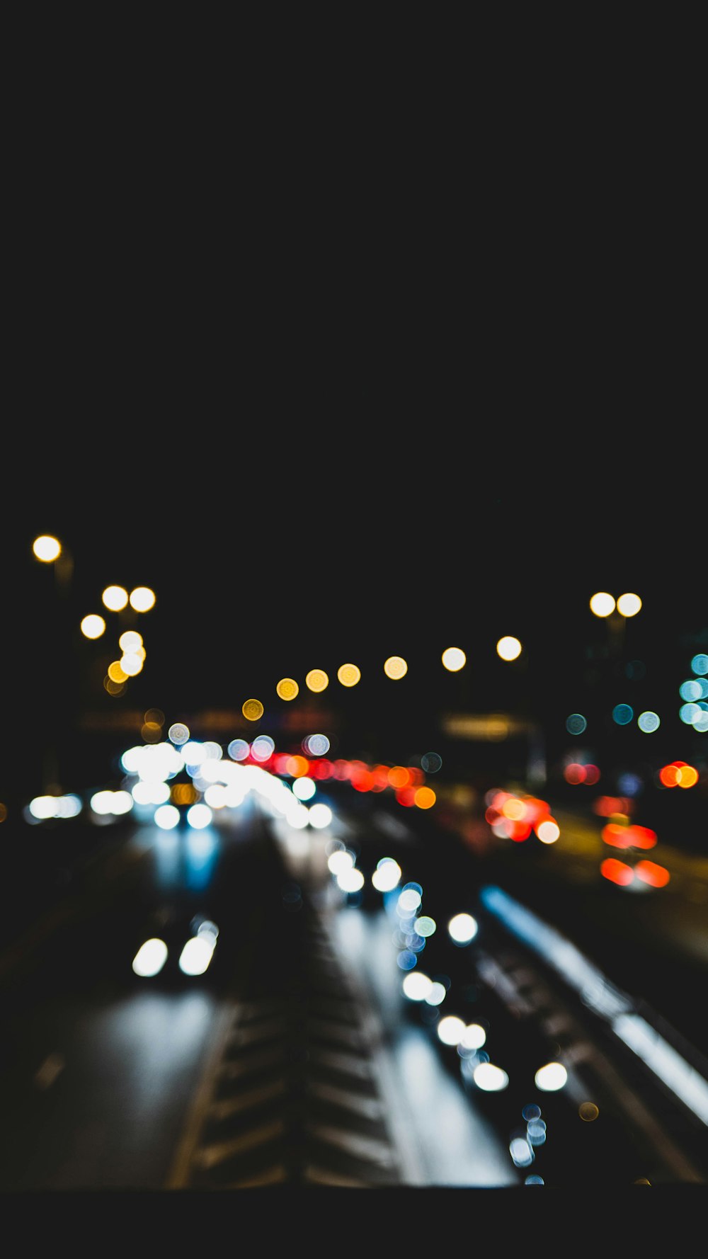 a city street filled with lots of traffic at night