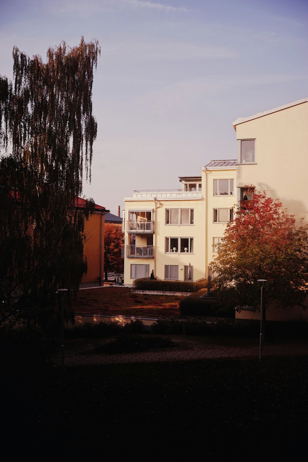 white concrete house near tree