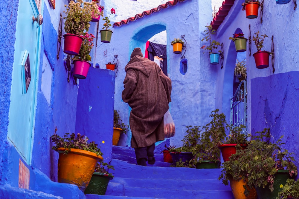 man walks on purple stairs