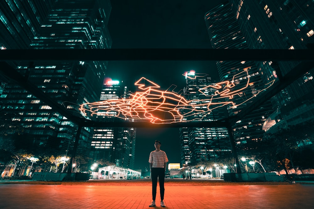 man standing near building at night