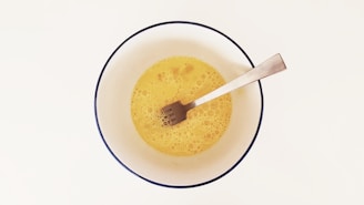 yellow beverage inside cup