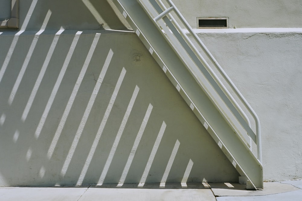 white stairwell casting shadow on ground below