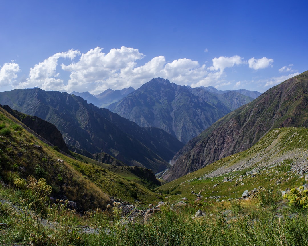 mountain under blue sky and white clouds at daytime