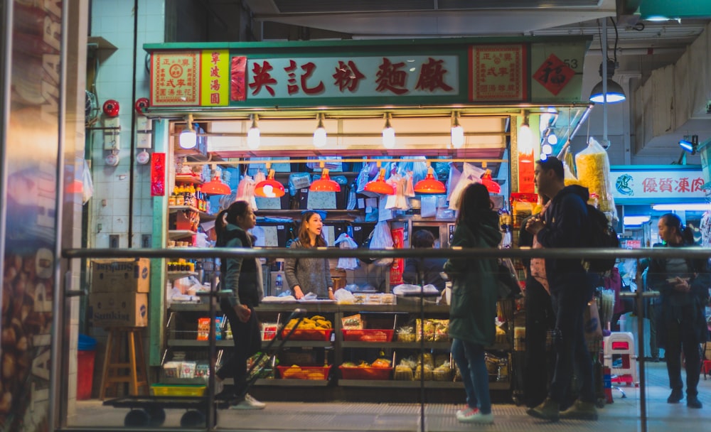 man and woman walking on nightmarket